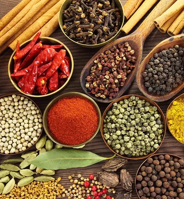 A collection of colorful spices and herbs displayed in small bowls, showcasing a variety of textures and colors.