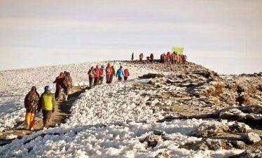 climber on top of kilimanjaro mountain